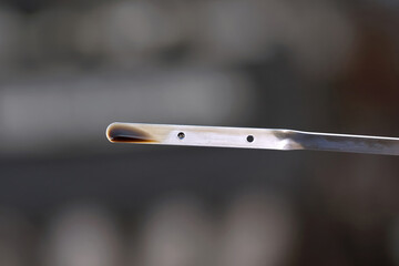 Car engine dipstick showing low oil level and old dirty motor oil closeup, automotive maintenance,...