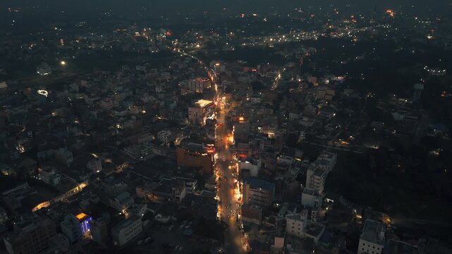 Aerial Night Timelapse of Busy City Street Traffic and Urban Glow in Metropolitan India Night