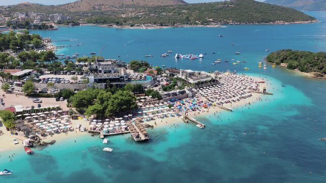 Aerial view of the vibrant Ksamil beach, where the turquoise sea meets the sandy shore, creating a stunning contrast, Ksamil, Vlore County, Albania.