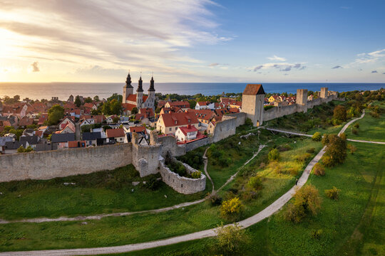 drone panorama cityscape of Visby with the medieval city wall and landmark cathedral at sunset