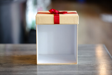 Front View of Open Empty Beige Gift Box with Red Ribbon on Lid, Ready for Mockup