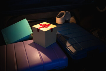 Christmas Gift Box and Suitcases in Car Trunk, Concept for Holiday Travel and Gifting