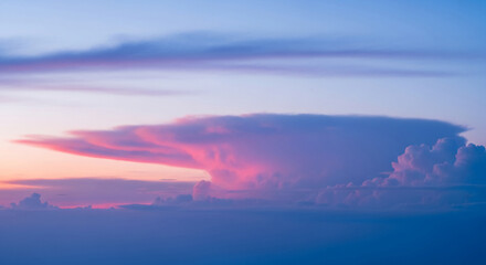 Vibrant cloudscape with pastel hues. Pink and blue clouds are layered, creating depth and evoking peaceful, dreamy atmosphere, perfect for meditation