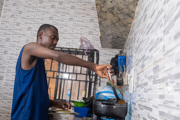Man stirring food in a pan while cooking in the kitchen.