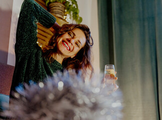 Young pretty woman drinking champagn during Christmas Holidays retro style photo