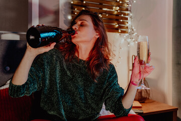 Young pretty woman drinking champagn during Christmas Holidays retro style photo