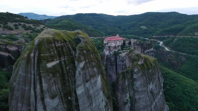 Aerial view of the Meteora Monastery perched atop towering cliffs, a blend of nature's grandeur and human endeavor, Kalampaka, Trikala, Greece.