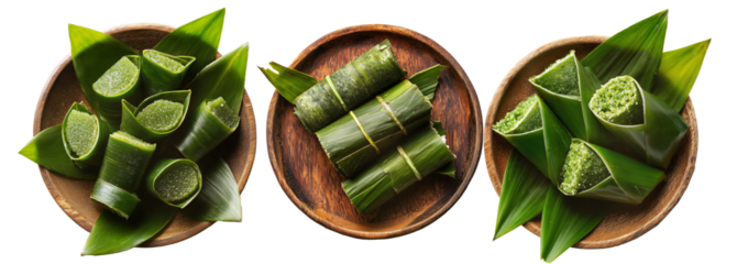 Set of Pandanus fruit wraps or asian rice cakes wrapped in green banana leaves placed on wooden plate isolated on white background