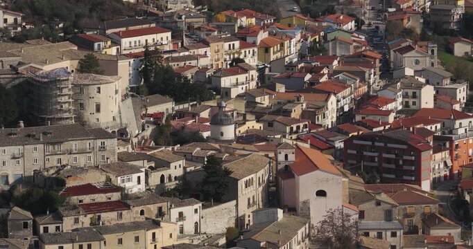 Aerial view of Gesualdo's ancient castle and churches, nestled among terracotta rooftops and winding roads, a tapestry of history and architecture, Gesualdo, Irpinia, Italy.