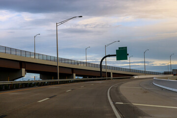 Highway overpass with cloudy sky during late afternoon