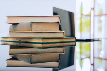 Books were arranged on the executive's desk, with a laptop beside it.