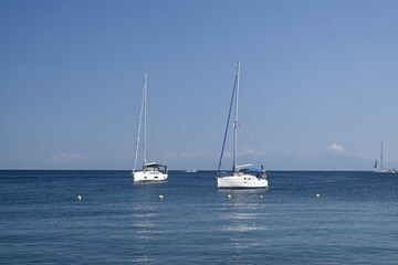 Fototapeta premium Luxury yachts anchored in the calm blue sea near Parga, Greece.