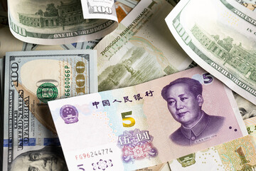 Overlapping Collage of US Dollar and Chinese Yuan Banknotes