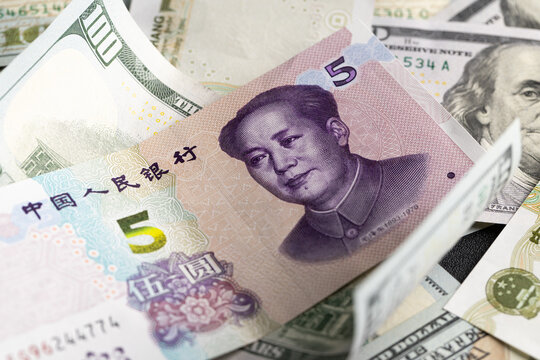 Overlapping Collage of US Dollar and Chinese Yuan Banknotes