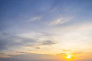 Obraz premium Sunset sky clouds background. Beautiful landscape with clouds and orange sun on sky,Orange sky and clouds background,Background of colorful sky concept, amazing sunset with twilight sky and clouds.