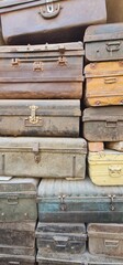 ollection of Aged and Corroded Iron Suitcases Stacked Neatly to Form a Decorative Background, Emphasizing the Patina, Rustic Colours, and Historical Aesthetic of Old Travel Gear