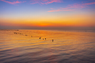 The sea and the sky at sunrise in the morning,Beautiful sunrise at sea. Dawn on the Red Sea. The sun is reflected in the sea. Light clouds in the blue dawn sky. Tropical sunrise