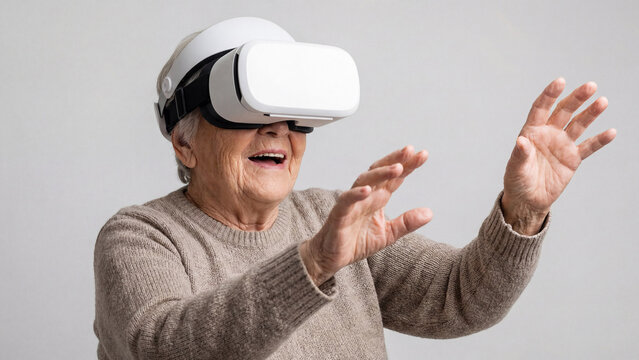 Amazed senior woman using virtual reality headset. Happy elderly lady reaching out hands in VR experience. Future technology and entertainment concept - Powered by Adobe