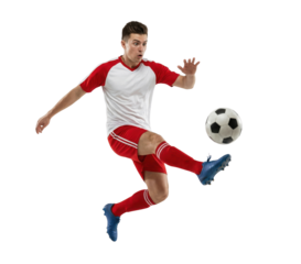 Soccer player in red uniform kicking ball isolated on white background