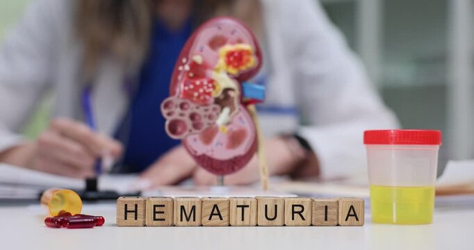 Woman physician records presence of blood in urine as clinically significant sign. Experienced doctor prepares notes for diagnosis by word Hematuria