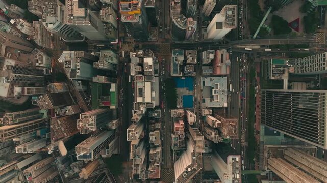 Aerial view of densely packed buildings intersected by busy roads creating a stark contrast of concrete and motion, Hong Kong, Hong Kong Island, Hong Kong.