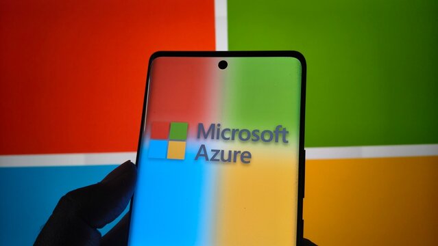 Smartphone displaying microsoft azure logo against colorful microsoft branding background