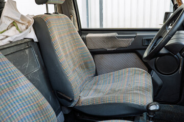 European family car interior view. Decaying fabric seats and plastic, wide angle view, no people