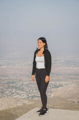 Woman Standing on Mountain Trail Overlooking Valley