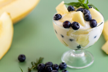 Summer vitamin cream yogurt with melon blueberries and mint