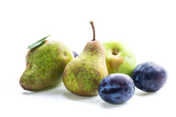 Autumn harvest of ripe pears and blue plums