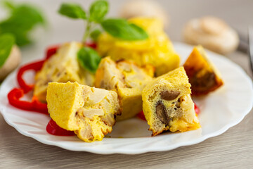 Delicious golden omelet with mushrooms and cauliflower pieces