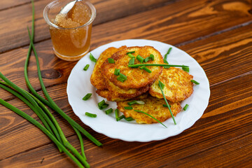 Crispy potato fritters served warm on rustic background