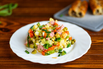 Classic olivier salad served fresh on white plate