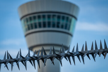 Security Fence with Anti-Climb Spikes in Front of an Airport Air Traffic Control Tower