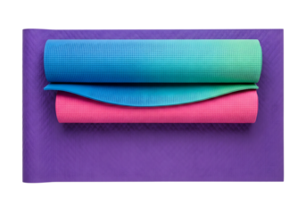 Colorful yoga mats stacked on purple mat