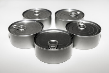 Canned tuna food supplies in aluminum containers on white background.