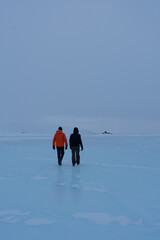 Two men walking on ice, frozen lake or gletsjer