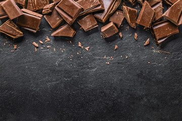 Dark chocolate chunks on black slate background