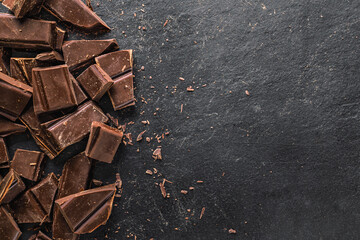 Dark chocolate chunks on black slate background
