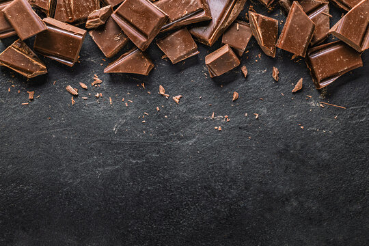 Dark chocolate chunks on black slate background