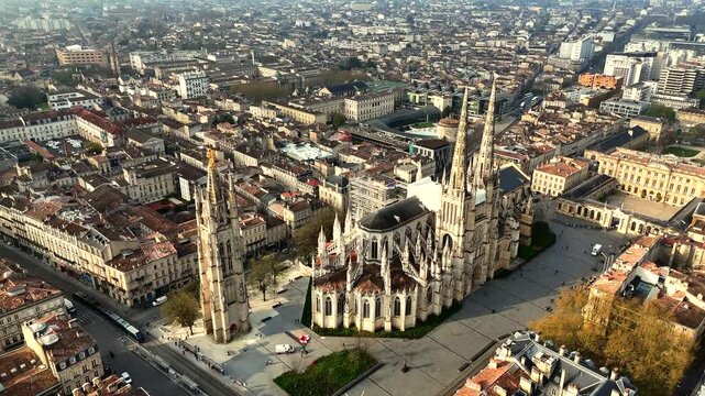 Drone orbit of Bordeaux Saint-Andre Cathedral and Pey Berland tower in golden hour