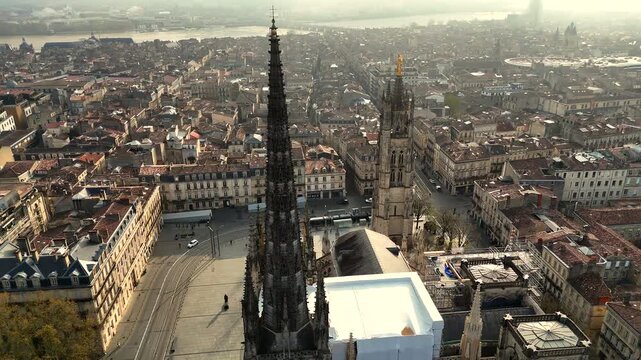 Drone shot of Bordeaux Saint-Andre Cathedral twin spires and Pey Berland tower at sunset