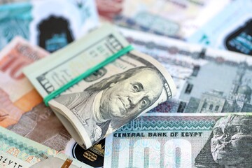 Egyptian pound currency money bills and bunch of us dollar banknotes close up. The concept of economics and currency exchange
