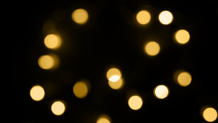 glowing lights in the dark,yellow glitter bokeh lights on black background,abstract background of gold bokeh lights,light leak overlay effect with bokeh ,Christmas xmas bokeh backgroud