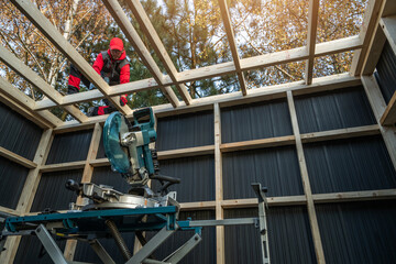 Worker Constructs a Wooden Frame for a New Shed