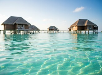 Fototapeta premium Serene Overwater Bungalows on Crystal Clear Turquoise Water Under a Bright Sunny Sky