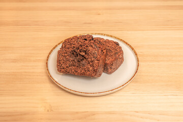 Intense chocolate cake with a molten ganache center, presented as an individual serving with vanilla ice cream and raspberry sauce
