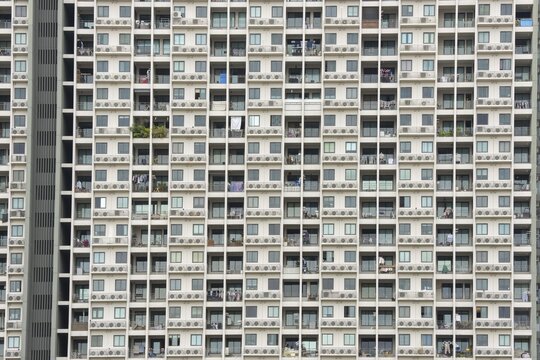 Exterior fa&ccedil;ade of a residential high-rise building of Condo U (a brand or series name of the Thai real estate developer Grand Unity Development Co., Ltd. (often abbreviated Grand U), Bangkok Yai district, the old town of Bangkok, Thailand