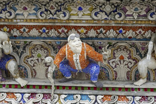 Decorative elements with pop culture references (for example comics, superheroes) in the stucco and porcelain vases outside and inside the art hall with modern art trends such as minimalism and abstraction, Wat Pariwat, Yan Nawa district, Bangkok, Thailand