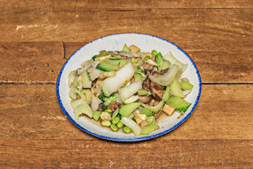 Fresh salad with cabbage, scallions, fresh cilantro, and sweet and sour pork strips, tossed with cellophane noodles and a lime and chili dressing